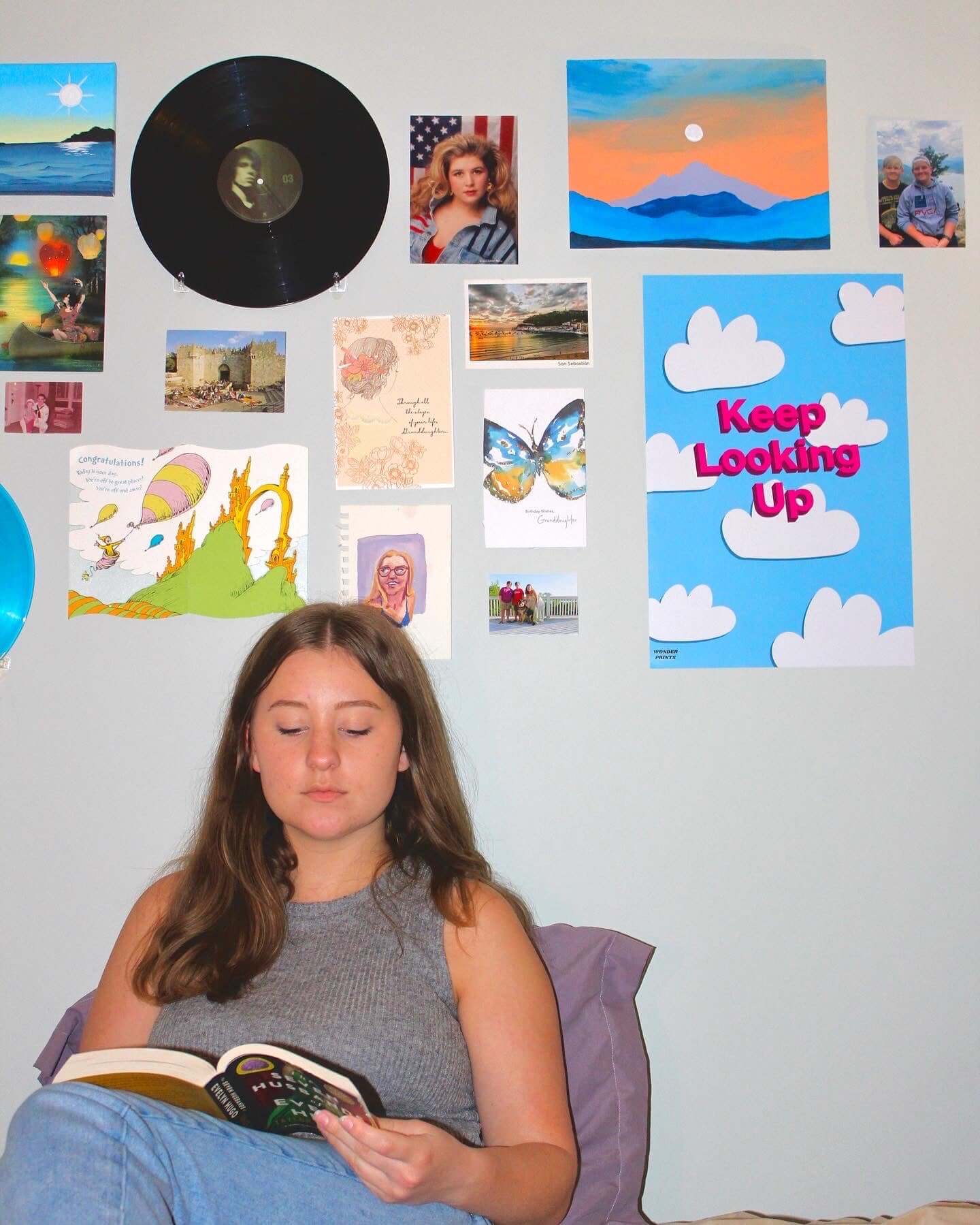 Girl reading with aesthetic design wall behind her, Cloudy Poster on wall