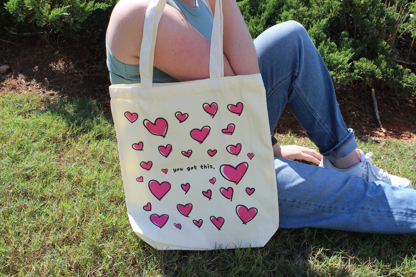 Girl sitting with Lots of Love tote over shoulder