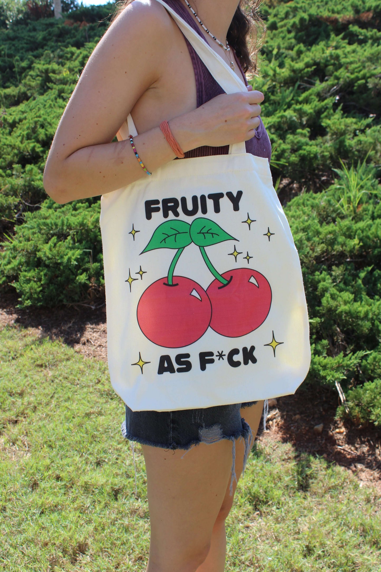 Girl with Fruity AF tote hanging from shoulder