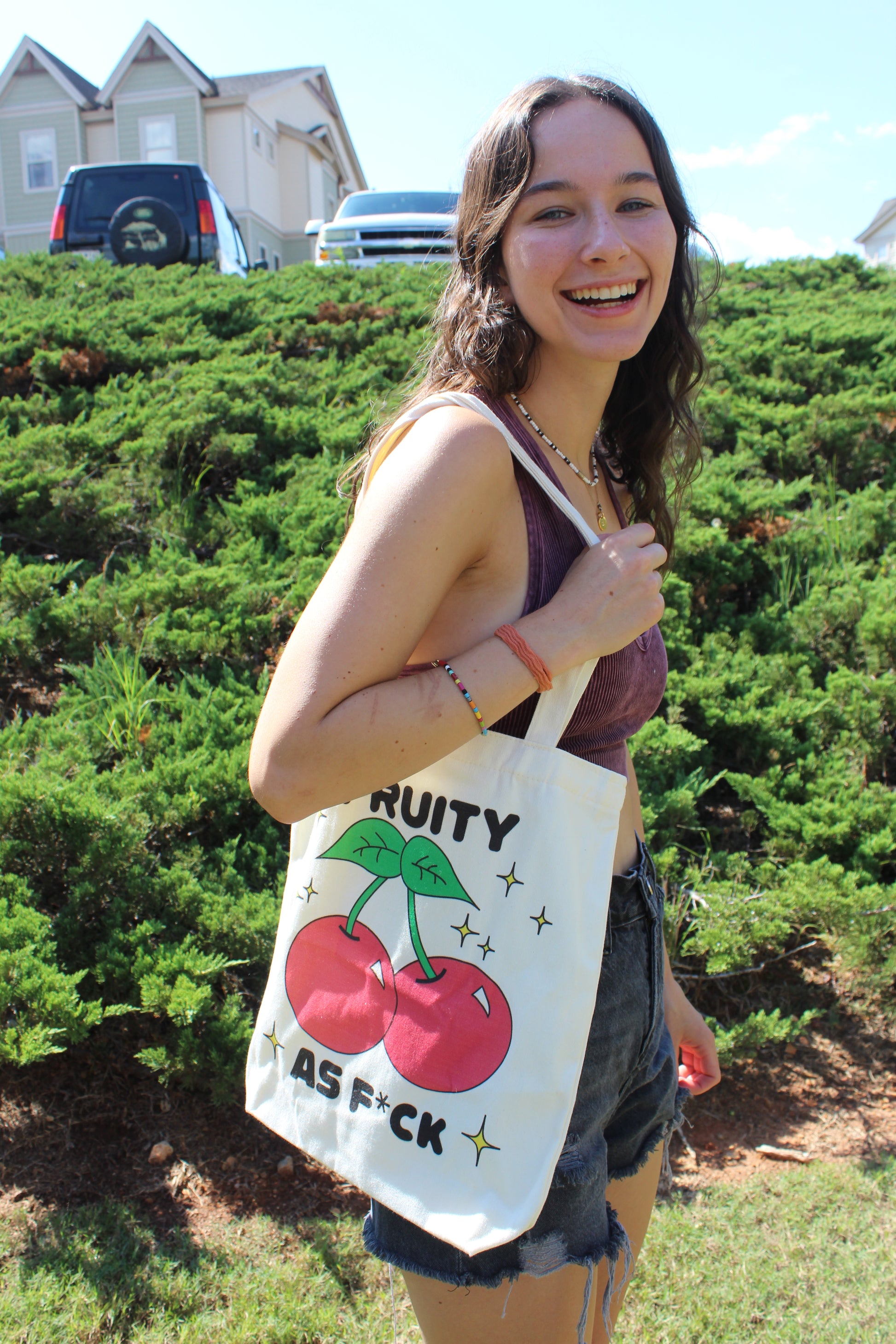 Girl smiling with Fruity AF tote hanging on shoulder