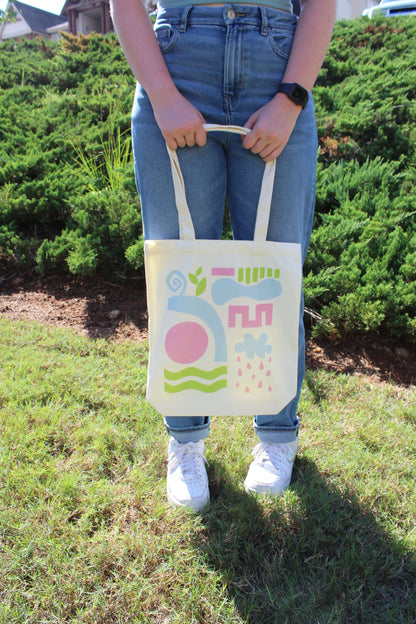 Holding Abstract Tri Color Tote Bag in front of body with two hands