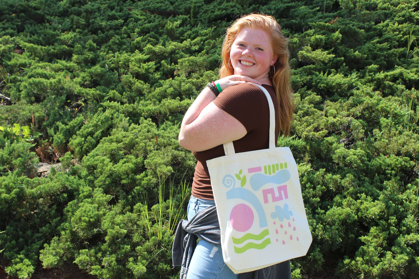 Girl smiling while holding Abstract Tri Color Tote Bag over shoulder