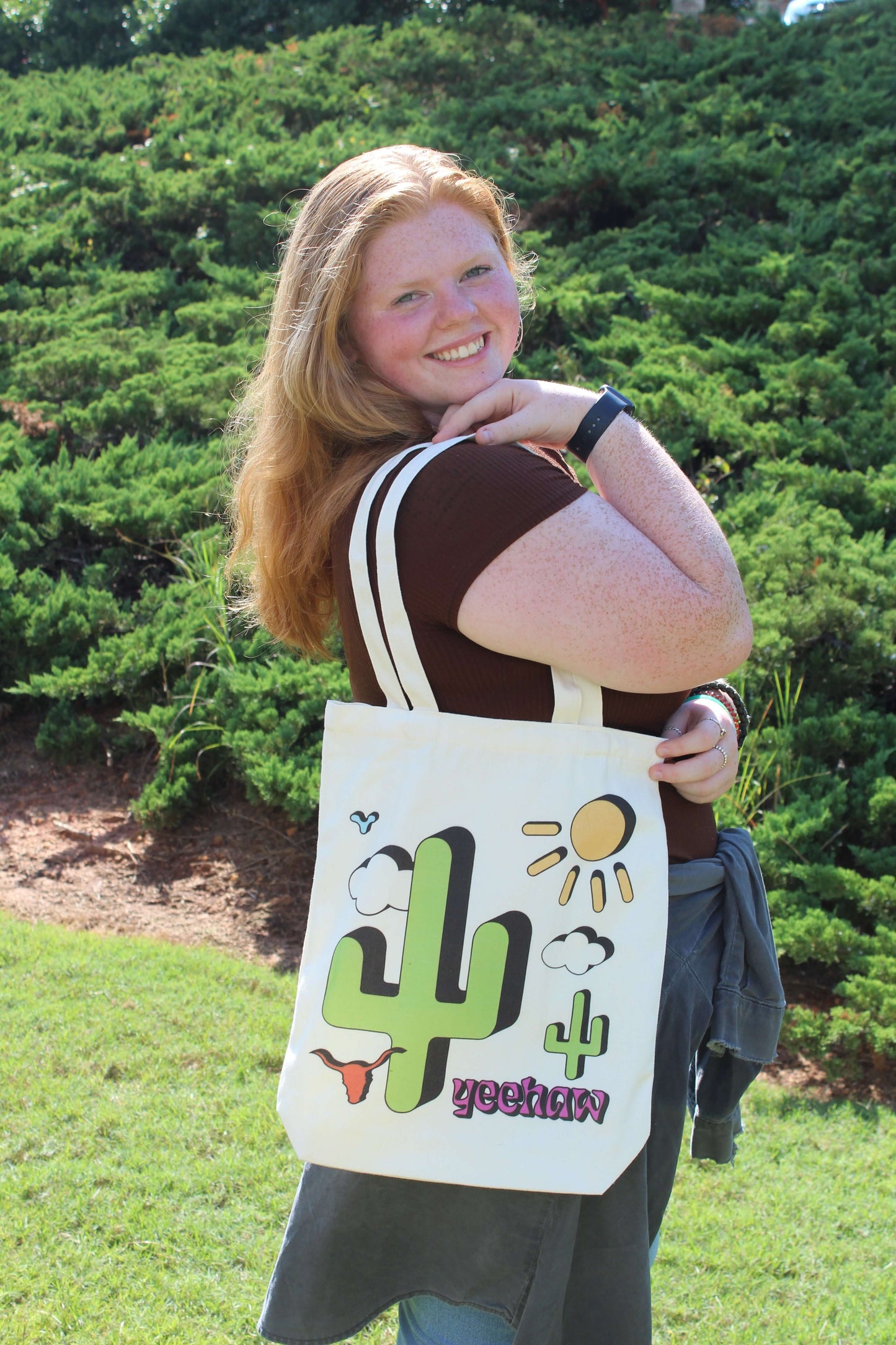 Smiling girl with Western Cowgirl tote over shoulder outside