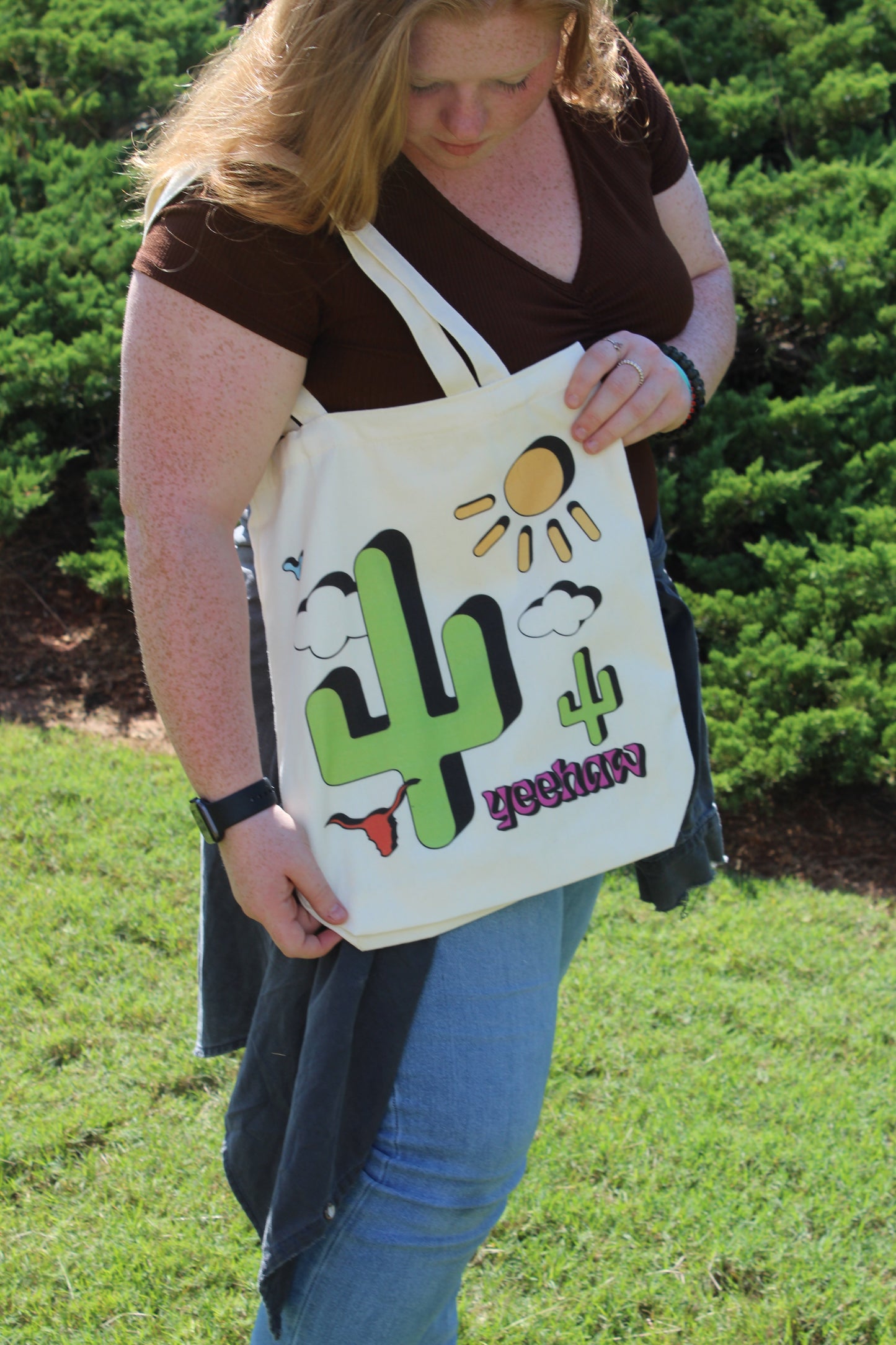 Girl looking down at Western Cowgirl tote over shoulder outside