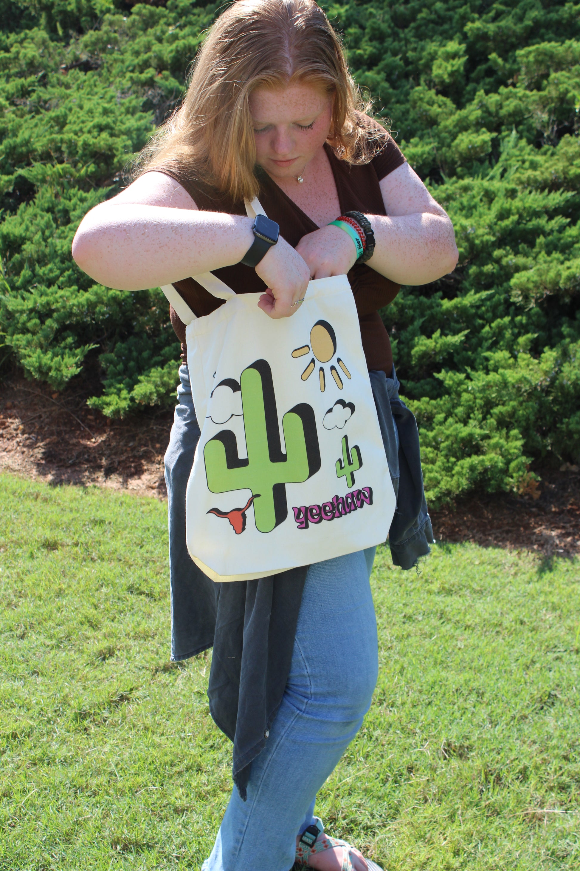 Girl looking inside Western Cowgirl tote outside