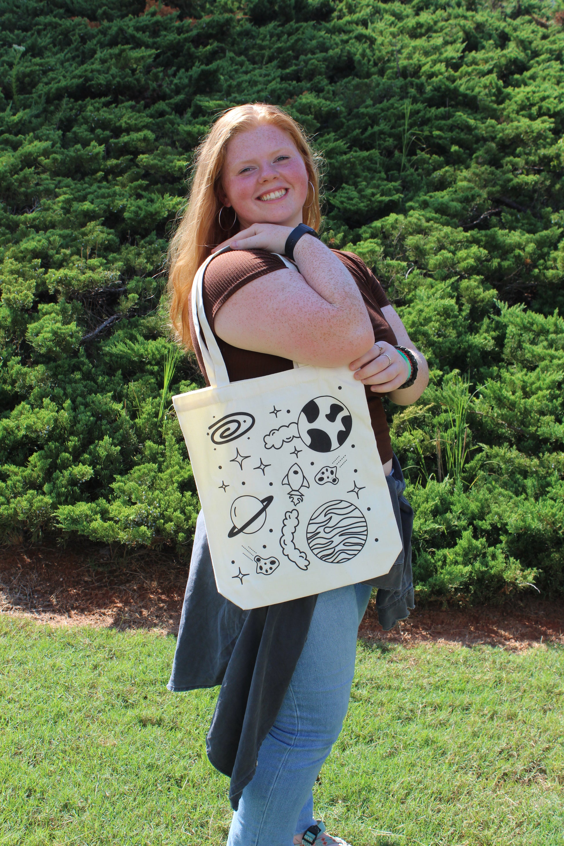 Smiling girl looking back with Spaced Out tote