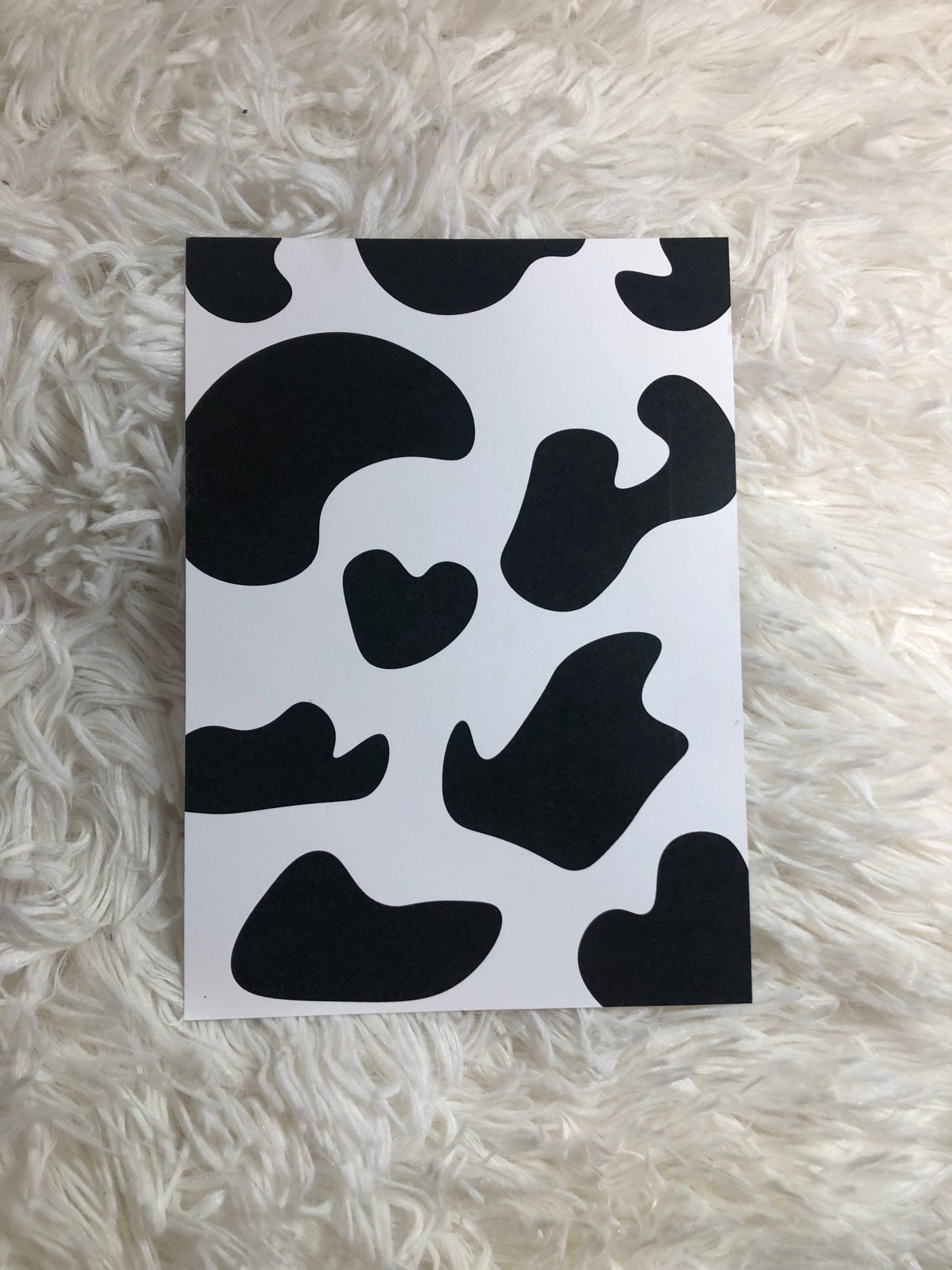 Cow print postcard with fluffy background