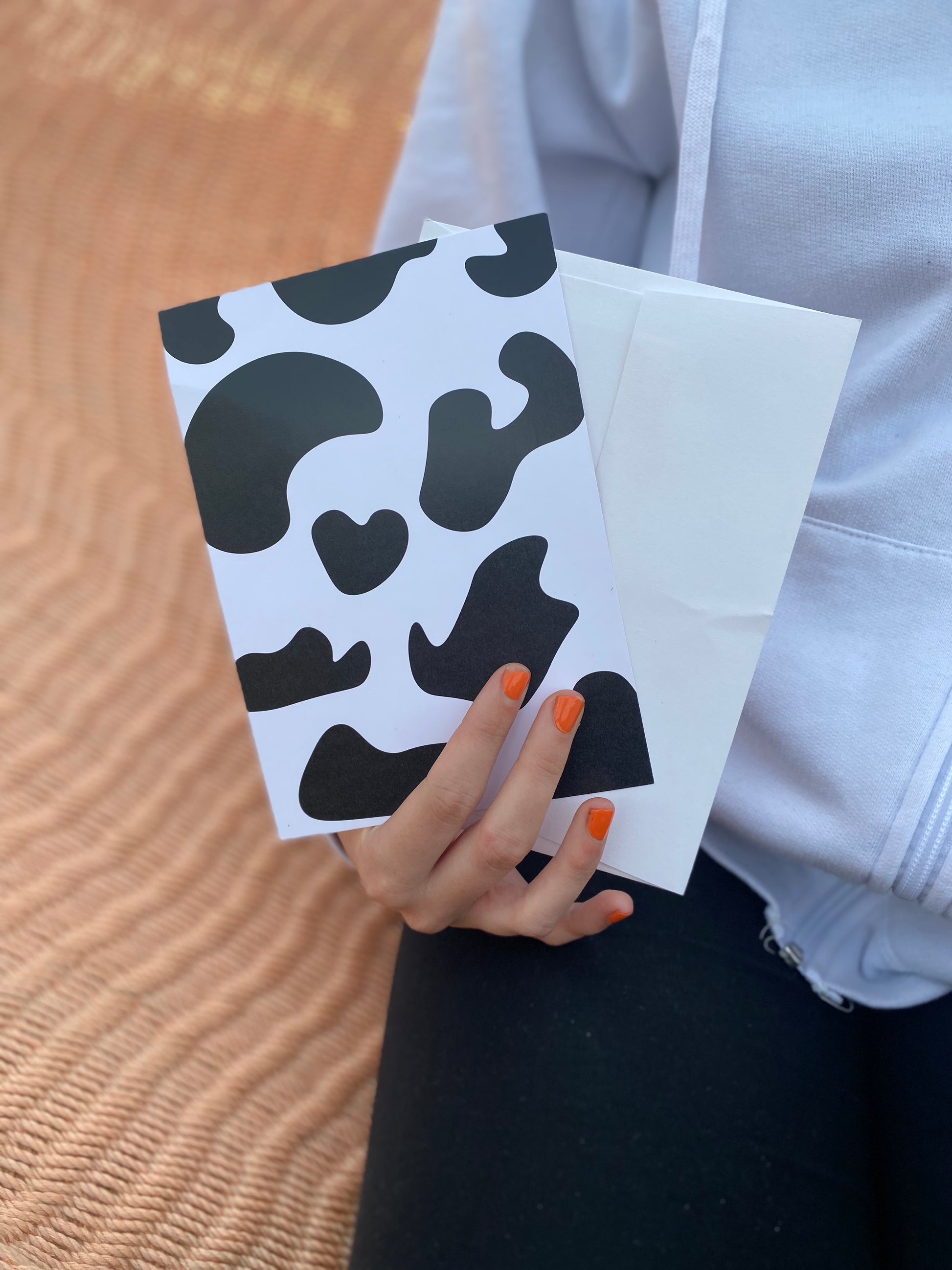 Girl holding Cow print postcard with envelope