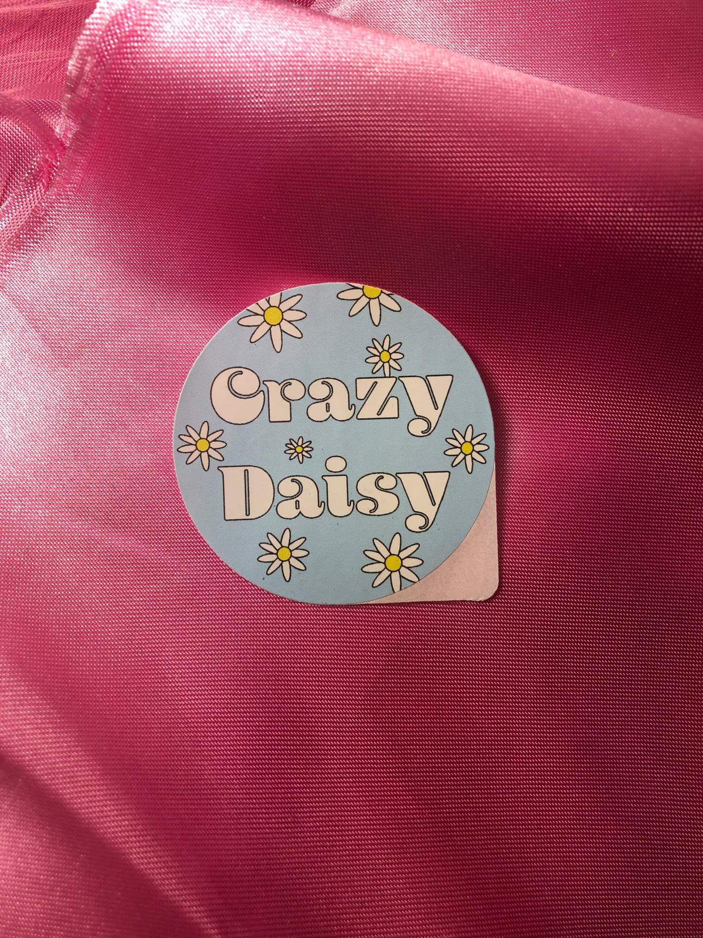 Crazy Daisy sticker with red background