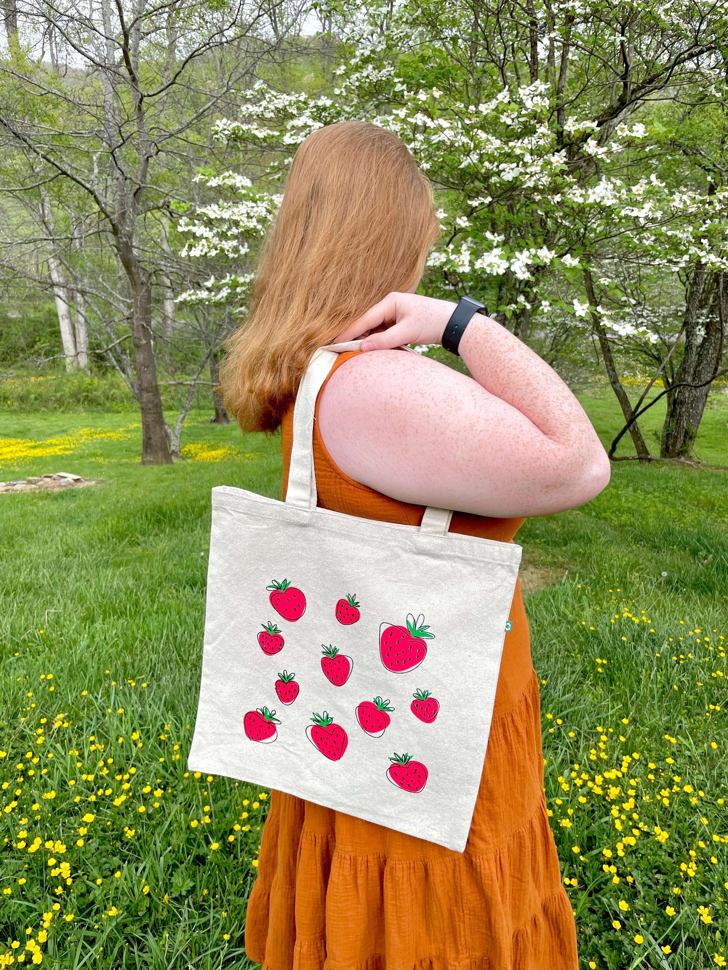 Girl looking away with Super Berry tote over shoulder outside