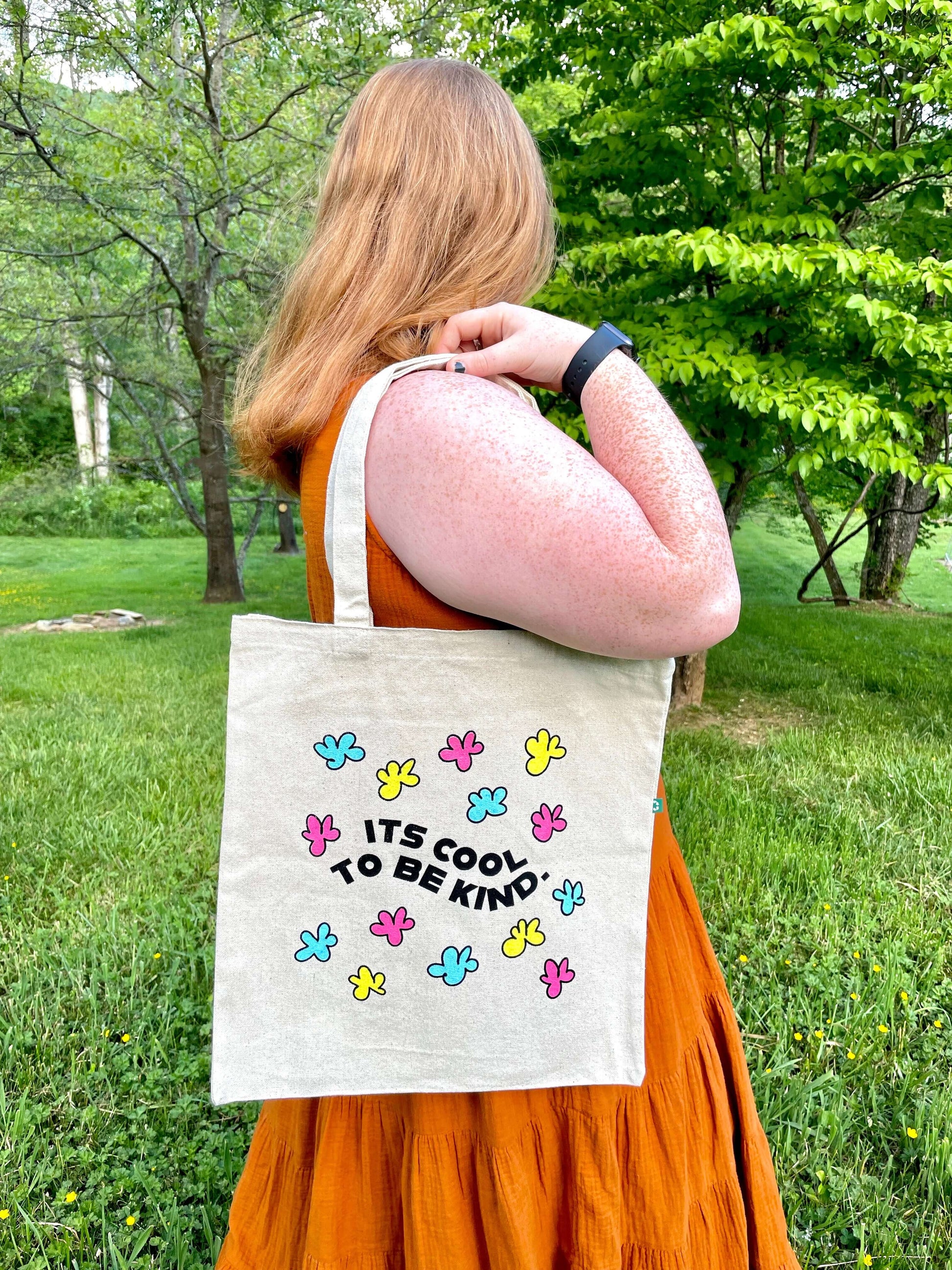 Kindness is Cool tote hanging over shoulder