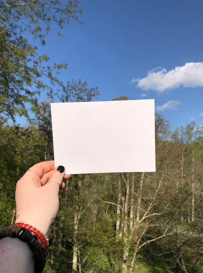 hand holding card with blank background outside